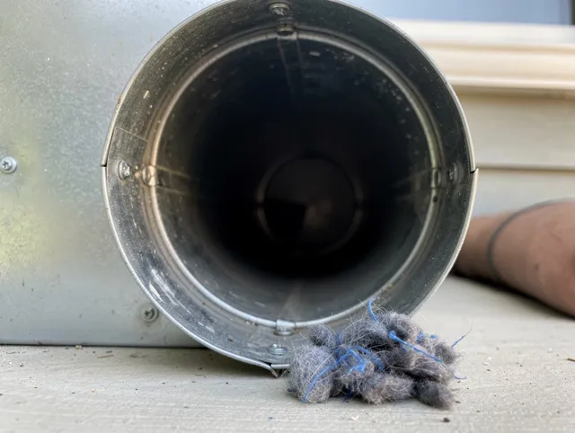Canton Dryer Vent Cleaning technician using specialized equipment to clear severe dryer vent blockage in Canton